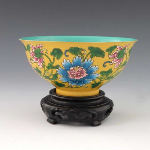 448 - A Chinese polychrome bowl, Kangxi mark, ogee form, yellow ground, enamelled with flowers and scrolli... 