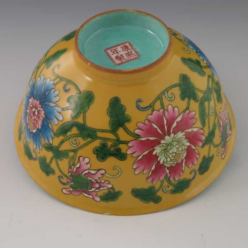 448 - A Chinese polychrome bowl, Kangxi mark, ogee form, yellow ground, enamelled with flowers and scrolli... 