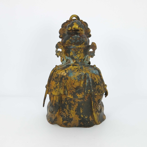 460 - A large Chinese gilt bronze figure of a deity, seated cross legged and wearing a headdress, mounted ... 