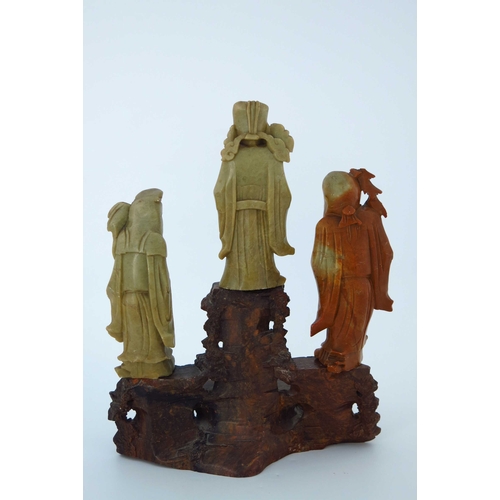 470 - A Chinese soapstone carving, in the form of five robed figures mounted upon a rocky outcrop, 34cm hi... 