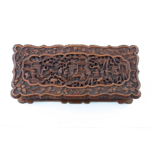 477 - A late 19th Century Cantonese wooden table casket, carved throughout with figures and pagodas in woo... 