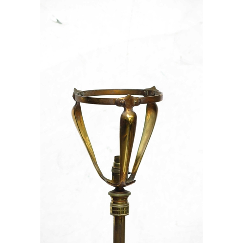 480a - An Arts and Crafts telescopic brass standard lamp, on three scrolling tendril feet, converted from o... 