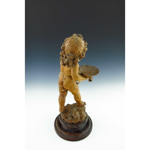 483 - An Italian fruitwood carte de visite stand, 19th Century, in the form of a standing cherub presentin... 