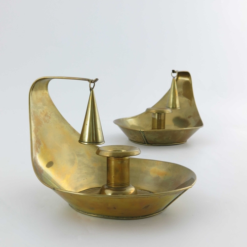 503 - Christopher Dresser for Richard Perry Son and Co., a pair of Aesthetic Movement brass chambersticks,... 