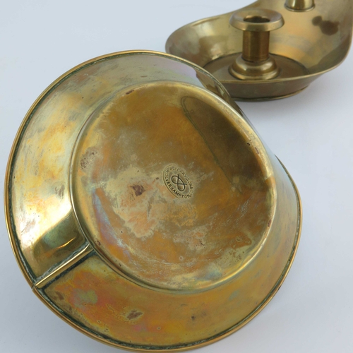 503 - Christopher Dresser for Richard Perry Son and Co., a pair of Aesthetic Movement brass chambersticks,... 