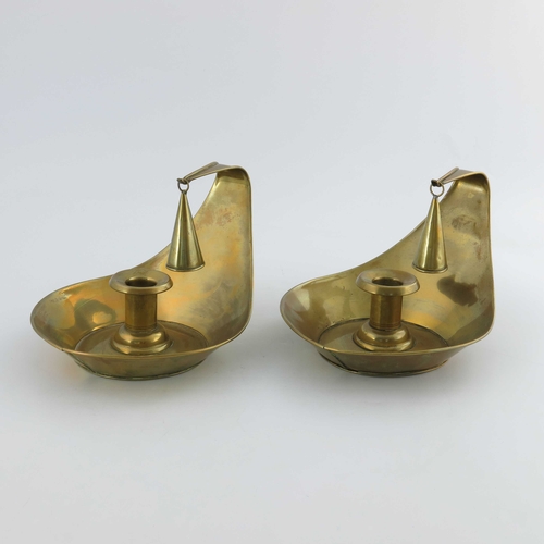 503 - Christopher Dresser for Richard Perry Son and Co., a pair of Aesthetic Movement brass chambersticks,... 