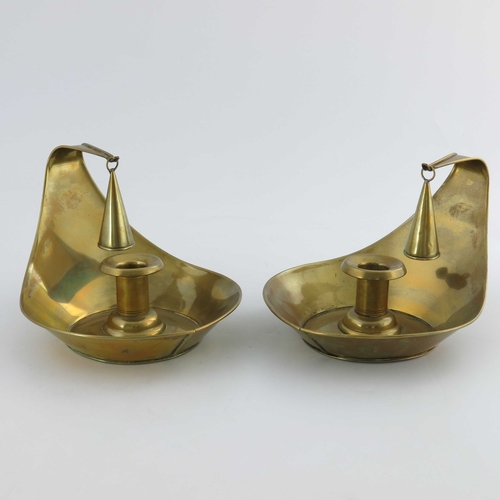 503 - Christopher Dresser for Richard Perry Son and Co., a pair of Aesthetic Movement brass chambersticks,... 