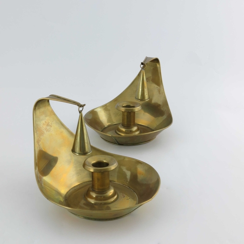 503 - Christopher Dresser for Richard Perry Son and Co., a pair of Aesthetic Movement brass chambersticks,... 