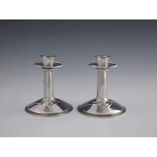 516 - Archibald Knox for Liberty and Co., a pair of Arts and Crafts Tudric pewter candlesticks, model 023,... 