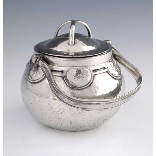 524 - Liberty and Co., an Arts and Crafts Tudric pewter biscuit barrel, mode 01561, planished ovoid form, ... 