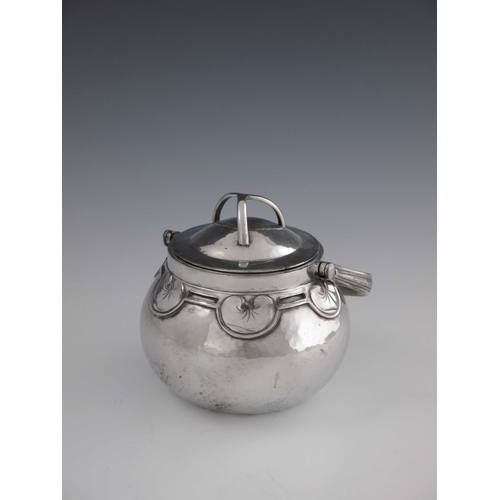 524 - Liberty and Co., an Arts and Crafts Tudric pewter biscuit barrel, mode 01561, planished ovoid form, ... 