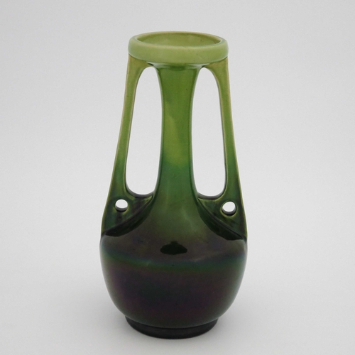 639 - A Bretby art pottery vase, twin handled bottle form, with pierced holes to the angled handles, green... 