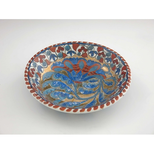 640 - John Pearson, an Arts and Crafts lustre plate, circa 1890, circular dished form, painted with a flow... 