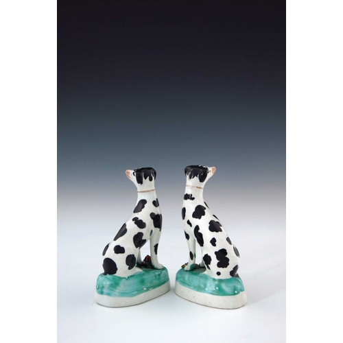 776 - A pair of mid 19th Century Staffordshire chimney dogs, circa 1860, seated with blackberry spots, Dis... 