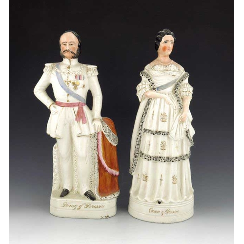 777 - A pair of Staffordshire figures of the King and Queen of Prussia, circa 1870, modelled standing on p... 