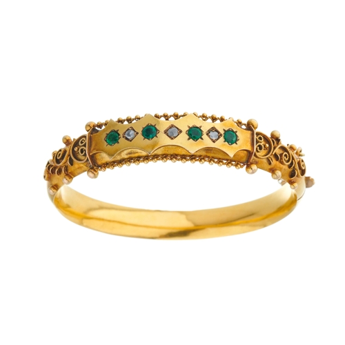 10 - A late 19th century 9ct gold emerald and rose-cut diamond hinged bangle bracelet, with bead border a... 