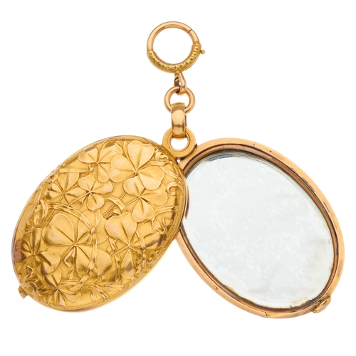24 - An Art Nouveau 18ct gold mirror locket pendant, decorated with shamrocks to the front and reverse, w... 