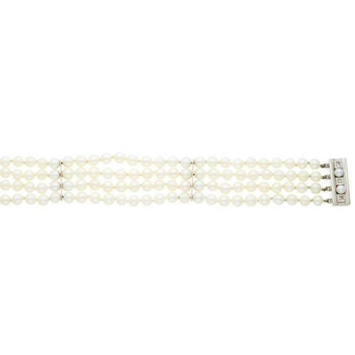 31 - A four-row cultured pearl bracelet, with 18ct gold single-cut diamond and cultured pearl sliding cla... 