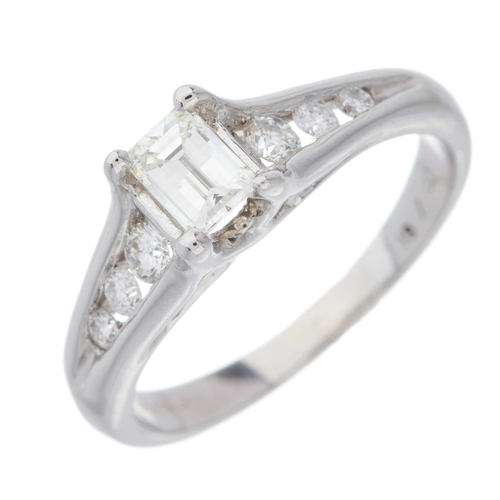 73 - An 18ct gold millennium-cut diamond single-stone ring, with brilliant-cut diamond tapered shoulders,... 