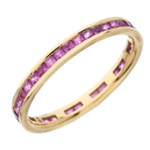 83 - An 18ct gold calibre-cut pink sapphire full eternity ring, estimated total pink sapphire weight 1ct,... 