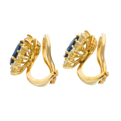 101 - A pair of 18ct gold oval-shape sapphire and brilliant-cut diamond cluster earrings, with hinged clip... 