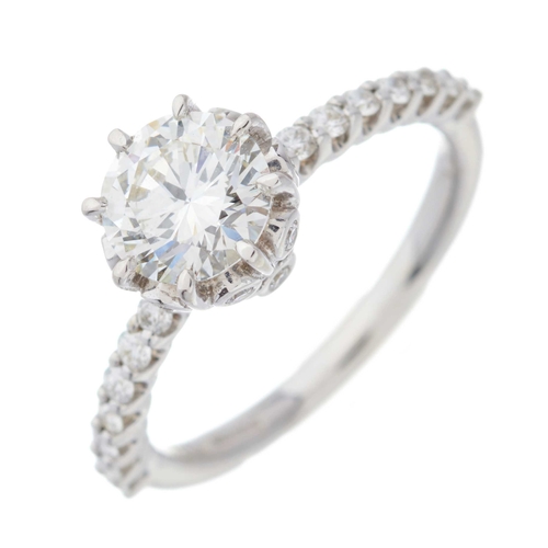 116 - An 18ct gold brilliant-cut diamond single-stone ring, with similarly-cut diamond line shoulders, pri... 