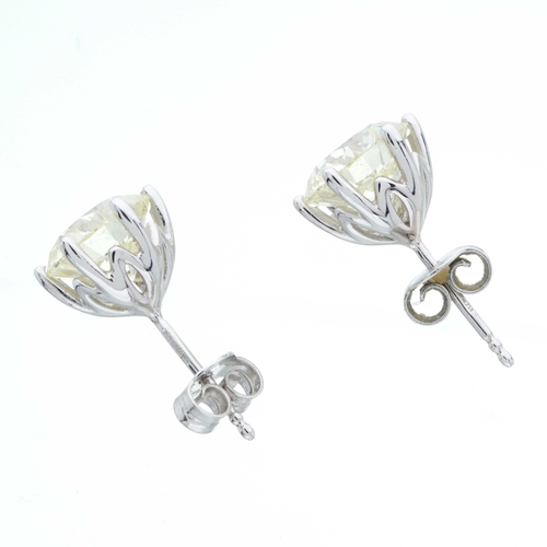 125 - A pair of 18ct gold brilliant-cut diamond stud earrings, estimated total diamond weight 5ct, tinted ... 