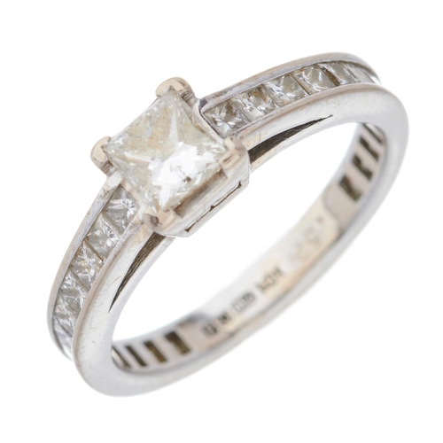 202 - An 18ct gold square-shape diamond single-stone ring, with calibre-cut diamond line shoulders and gal... 