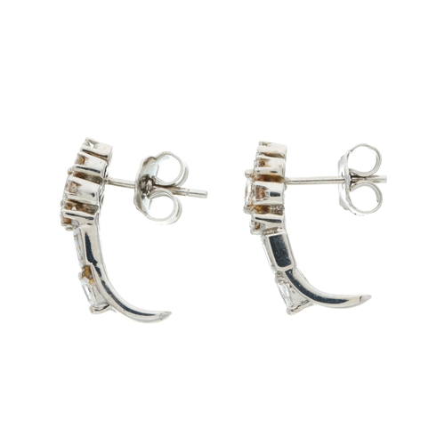 212 - A pair of 18ct gold diamond earrings, each designed as a vari-cut diamond panel, with slightly curve... 