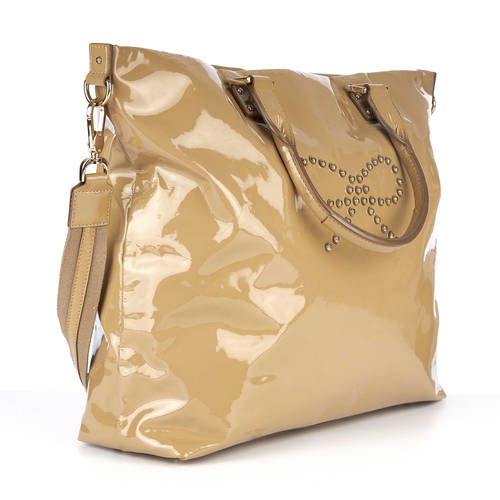 267 - Anya Hindmarch, a beige patent leather handbag, featuring gold-tone hardware, studded bow logo embel... 