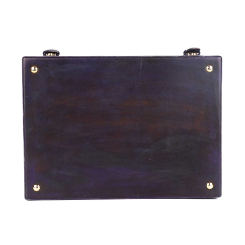 273 - Berluti, a leather shoe cleaning case, featuring a distressed purple leather exterior, with a flat t... 