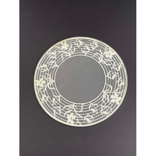 107 - An American silver overlay glass coaster, circular form, concentric bands with floral sprigs, 25cm d... 