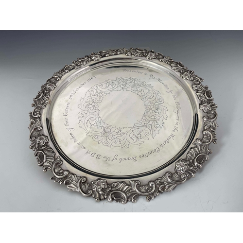 141 - A Victorian silver tray salver, Deykin and Harrison, Birmingham 1896, circular with applied cast fol... 