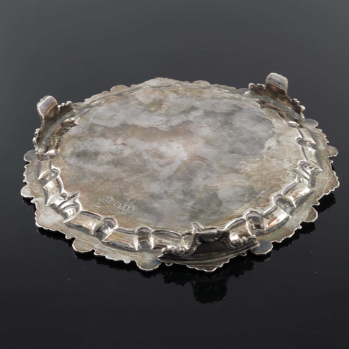 141 - A Victorian silver tray salver, Deykin and Harrison, Birmingham 1896, circular with applied cast fol... 