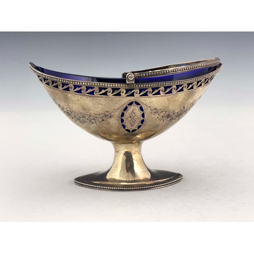 154 - A George III silver sugar basket, London 1787, pierced boat form with beaded swing handle, on oval f... 