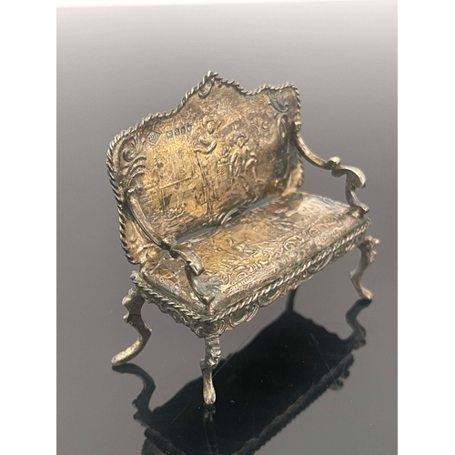 170 - An Edwardian silver miniature settee, Theodor Hartmann, London 1902, chased with scenes after Wattea... 