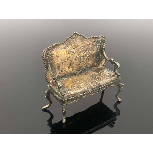 170 - An Edwardian silver miniature settee, Theodor Hartmann, London 1902, chased with scenes after Wattea... 