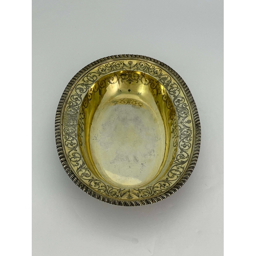 179 - A George III silver gilt basin dish, John Jacob, London 1764, oval broad rimmed form, gadrooned and ... 