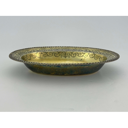 179 - A George III silver gilt basin dish, John Jacob, London 1764, oval broad rimmed form, gadrooned and ... 