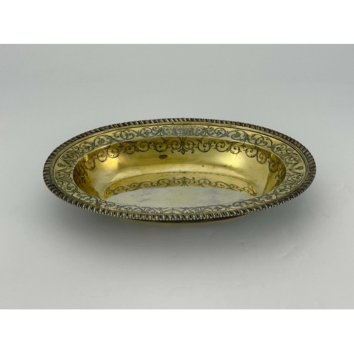 179 - A George III silver gilt basin dish, John Jacob, London 1764, oval broad rimmed form, gadrooned and ... 