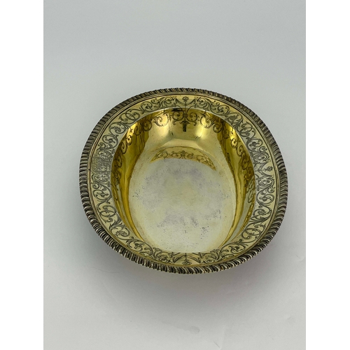 179 - A George III silver gilt basin dish, John Jacob, London 1764, oval broad rimmed form, gadrooned and ... 