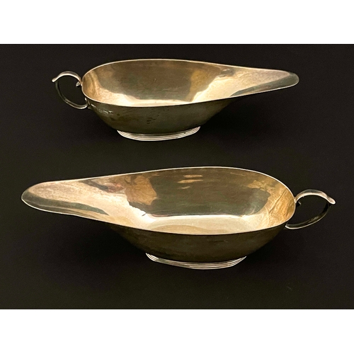 182 - A pair of George V silver sauce boats, S Blackensee and Son, Birmingham 1922, narrow slipper form wi... 