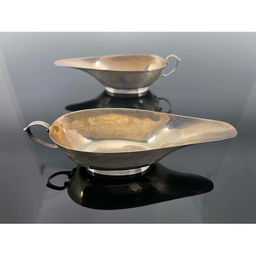 182 - A pair of George V silver sauce boats, S Blackensee and Son, Birmingham 1922, narrow slipper form wi... 