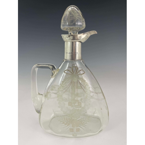 212 - A George V silver mounted glass claret jug, Birmingham 1912, Secessionist style wreath etched body, ... 