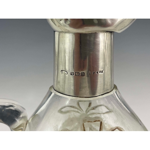 212 - A George V silver mounted glass claret jug, Birmingham 1912, Secessionist style wreath etched body, ... 