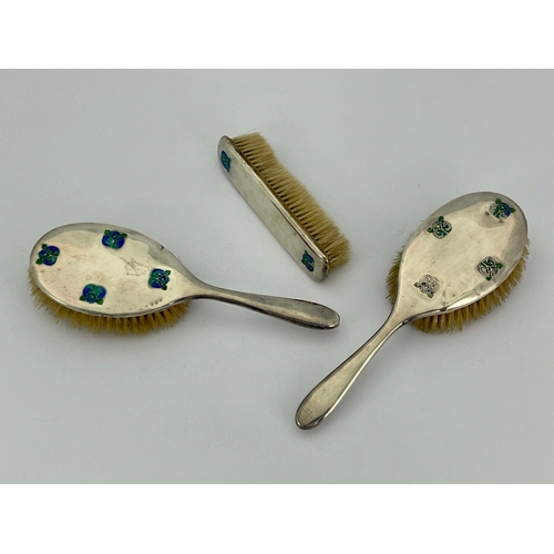 229 - Archibald Knox for Liberty and Co., a set of three Arts and Crafts silver and enamelled brushes, Bir... 