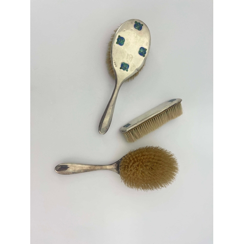 229 - Archibald Knox for Liberty and Co., a set of three Arts and Crafts silver and enamelled brushes, Bir... 