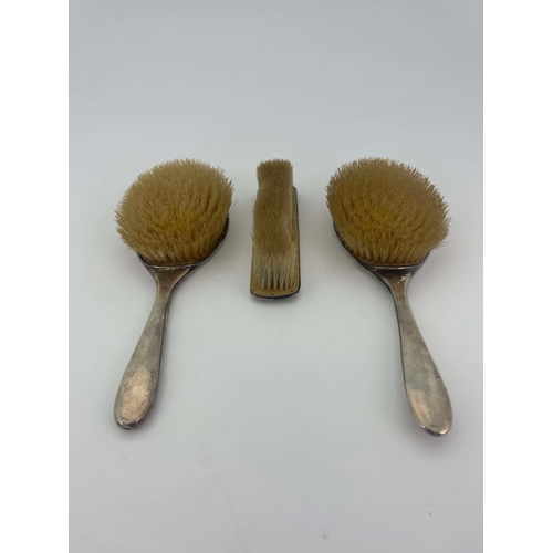 229 - Archibald Knox for Liberty and Co., a set of three Arts and Crafts silver and enamelled brushes, Bir... 