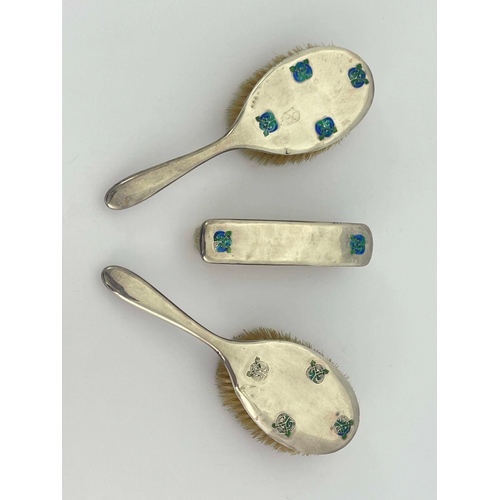 229 - Archibald Knox for Liberty and Co., a set of three Arts and Crafts silver and enamelled brushes, Bir... 