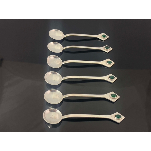 235 - A set of six Arts and Crafts white metal and gem set teaspoons, circa 1905, the planished circular b... 